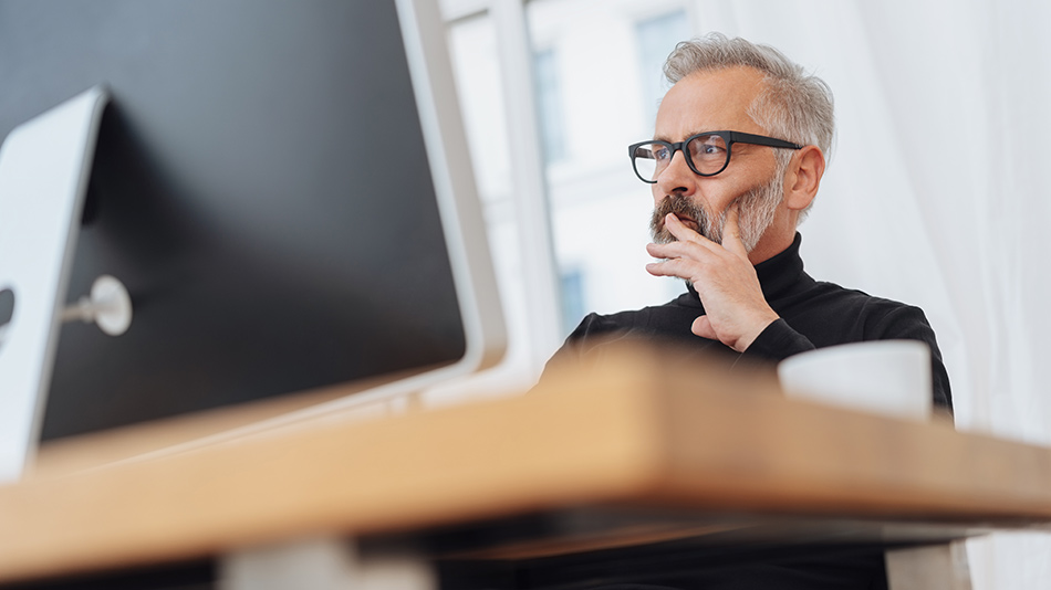 A older man sat thinking about "what causes blindness after cataract surgery"